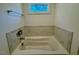 Close up of soaking tub with tiled backsplash at 262 Grand Griffon Way, Lillington, NC 27546