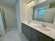 Modern bathroom featuring double vanity, sleek fixtures, and tiled floors at 262 Grand Griffon Way, Lillington, NC 27546