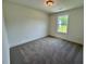 Bright bedroom featuring neutral carpet, natural light, and a simple ceiling fan at 262 Grand Griffon Way, Lillington, NC 27546