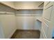 Bright walk-in closet with neutral walls, carpet, shelves and racks, providing plenty of storage options at 262 Grand Griffon Way, Lillington, NC 27546