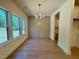 Dining room features hardwood floors, a decorative light fixture, and lots of natural light at 262 Grand Griffon Way, Lillington, NC 27546