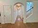 Inviting entryway with hardwood floors, arched ceiling, and access to the staircase at 262 Grand Griffon Way, Lillington, NC 27546