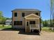 Back exterior elevation featuring a screened-in porch and neutral siding at 262 Grand Griffon Way, Lillington, NC 27546