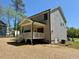 Exterior rear view, showcasing porch, siding, and outdoor space at 262 Grand Griffon Way, Lillington, NC 27546