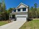 Two-story home with stone accents, neutral siding and a two car garage at 262 Grand Griffon Way, Lillington, NC 27546