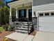 Inviting front entrance with stone accents, a covered porch, and a convenient attached garage at 262 Grand Griffon Way, Lillington, NC 27546