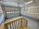 A clean, unfinished garage with a sectional door, offers ample space for vehicles and storage solutions at 262 Grand Griffon Way, Lillington, NC 27546