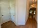 Bright hallway with hardwood floors and white trim leading to the living areas at 262 Grand Griffon Way, Lillington, NC 27546