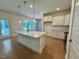 Bright, open kitchen features a large island with pendant lighting and views to the backyard at 262 Grand Griffon Way, Lillington, NC 27546