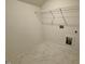 Laundry Room featuring neutral walls, tiled floor, and wire rack for storage at 262 Grand Griffon Way, Lillington, NC 27546