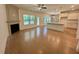 Open living space featuring hardwood flooring, fireplace, and seamless flow to the kitchen at 262 Grand Griffon Way, Lillington, NC 27546