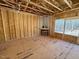 Spacious living room with large windows and a fireplace, currently under construction at 262 Grand Griffon Way, Lillington, NC 27546