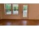 Living room featuring hardwood floors, backyard view, and access to the back porch at 262 Grand Griffon Way, Lillington, NC 27546