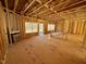 Living room under construction, featuring wood framing and large windows at 262 Grand Griffon Way, Lillington, NC 27546