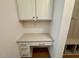 A well-organized mudroom with built-in desk and overhead storage, providing a convenient transition space at 262 Grand Griffon Way, Lillington, NC 27546