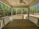 Cozy screened-in porch with wooden floors and views of the wooded backyard at 262 Grand Griffon Way, Lillington, NC 27546