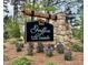 Stone sign for the Griffon Pointe community with blooming flowers at 262 Grand Griffon Way, Lillington, NC 27546