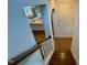 An interior staircase showcasing hardwood stairs and a view of the open concept kitchen at 262 Grand Griffon Way, Lillington, NC 27546