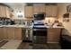 Kitchen featuring stainless steel appliances and wooden cabinetry at 305 W K St, Erwin, NC 28339