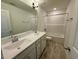 Bathroom features a double sink vanity, tile floors and a shower tub combo at 45 Covey Rise Way, Lillington, NC 27546