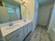Bathroom features a double sink vanity, a large mirror, and tile flooring at 45 Covey Rise Way, Lillington, NC 27546