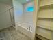 Bright bathroom features a soaking tub, separate shower, and built-in shelving at 45 Covey Rise Way, Lillington, NC 27546