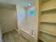 Bright bathroom with a tub, a window, and a shelf for storage at 45 Covey Rise Way, Lillington, NC 27546