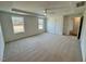 Bright carpeted bedroom with tray ceiling, ceiling fan, and natural light from the exterior windows at 45 Covey Rise Way, Lillington, NC 27546