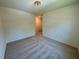 Neutral bedroom with a view to an adjoining room and a modern light fixture at 45 Covey Rise Way, Lillington, NC 27546