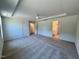 Neutral bedroom with carpet, ceiling fan, and multiple doorways to closet and bathroom at 45 Covey Rise Way, Lillington, NC 27546