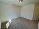 Neutral carpeted bedroom with ceiling light, electrical outlets, and white walls at 45 Covey Rise Way, Lillington, NC 27546