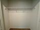 The bedroom closet has neutral walls and carpeting with a wire shelf for organization at 45 Covey Rise Way, Lillington, NC 27546