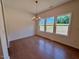 Dining room featuring hardwood floors, ample natural light from three windows, and a stylish chandelier at 45 Covey Rise Way, Lillington, NC 27546