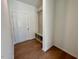 Entryway features hardwood floors, a coat rack, and a bench with cubbies for storage at 45 Covey Rise Way, Lillington, NC 27546