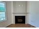 Fireplace with a dark interior, decorative mantel, and hardwood floors at 45 Covey Rise Way, Lillington, NC 27546