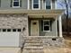 Close-up of the home's entryway with stone steps and visible 'Available' sign at 45 Covey Rise Way, Lillington, NC 27546