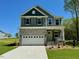 Charming two-story home with stone accents, a two-car garage, and a well-manicured lawn at 45 Covey Rise Way, Lillington, NC 27546