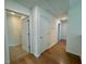 Upstairs hallway with hardwood flooring, white doors, and neutral decor at 45 Covey Rise Way, Lillington, NC 27546