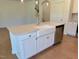 Kitchen island with a white farmhouse sink, stainless steel dishwasher, and white cabinets at 45 Covey Rise Way, Lillington, NC 27546