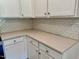 Detailed shot of the kitchen featuring white cabinets, light-colored countertops, and a classic subway tile backsplash at 45 Covey Rise Way, Lillington, NC 27546