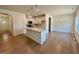 An open concept kitchen with pendant lighting, a center island and white cabinetry at 45 Covey Rise Way, Lillington, NC 27546