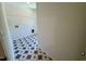 The laundry room has starburst tile floors and a wire shelf for storage at 45 Covey Rise Way, Lillington, NC 27546