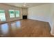 Bright living room featuring hardwood flooring, a fireplace, and a ceiling fan at 45 Covey Rise Way, Lillington, NC 27546