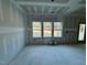 Living room with triple windows and recessed lighting at 45 Covey Rise Way, Lillington, NC 27546