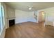Open living room featuring hardwood flooring, a fireplace, and an archway at 45 Covey Rise Way, Lillington, NC 27546
