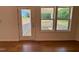 Bright living room with natural light and wood floors offers views of a deck and the yard at 45 Covey Rise Way, Lillington, NC 27546