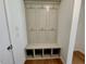 Mudroom features hardwood floors and a built-in coat rack with bench and storage cubbies at 45 Covey Rise Way, Lillington, NC 27546
