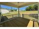 Covered porch with white railings and stained wooden floors looks out over the backyard at 45 Covey Rise Way, Lillington, NC 27546
