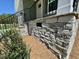Stone wall outside, landscaping includes shrubs and ground cover at 45 Covey Rise Way, Lillington, NC 27546