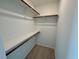 Bright walk-in closet featuring carpeted flooring and ample shelving space at 45 Covey Rise Way, Lillington, NC 27546